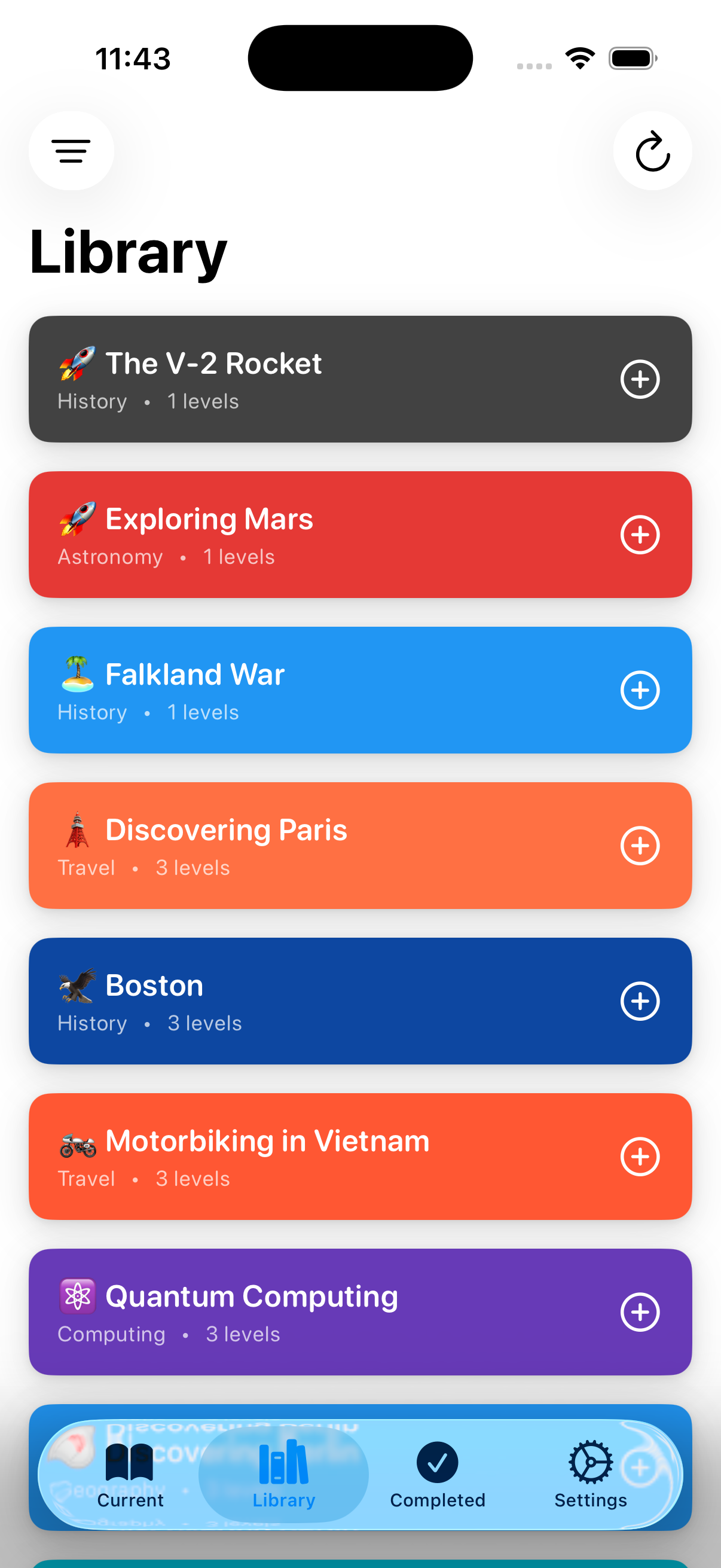 Library screen showing colorful topic cards including The V-2 Rocket, Exploring Mars, Falklands War, Discovering Paris, Boston, Motorbiking in Vietnam, and Quantum Computing